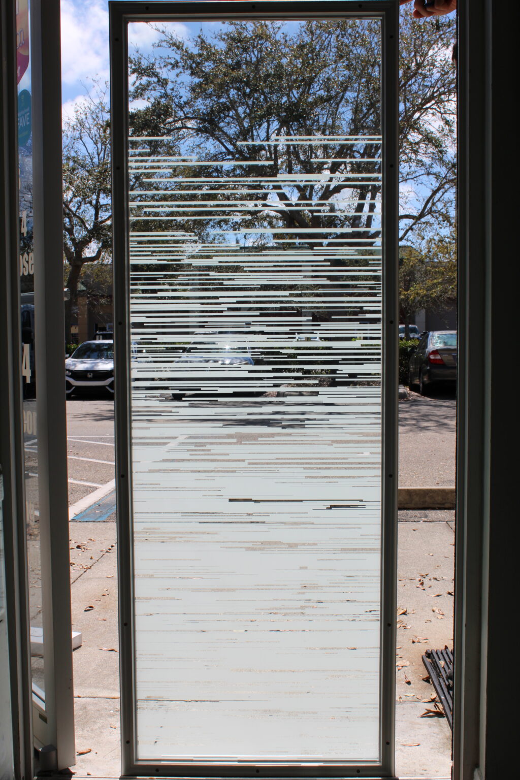 Modern frosted glass film with horizontal striped pattern offering privacy and light diffusion.