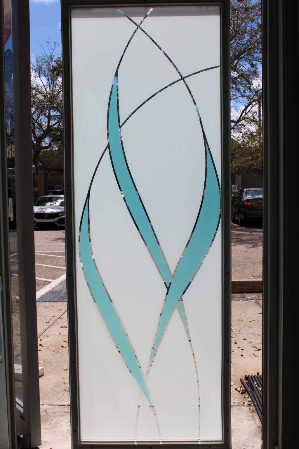 Decorative frosted glass film with aqua blue and clear wave accents for modern privacy and style.