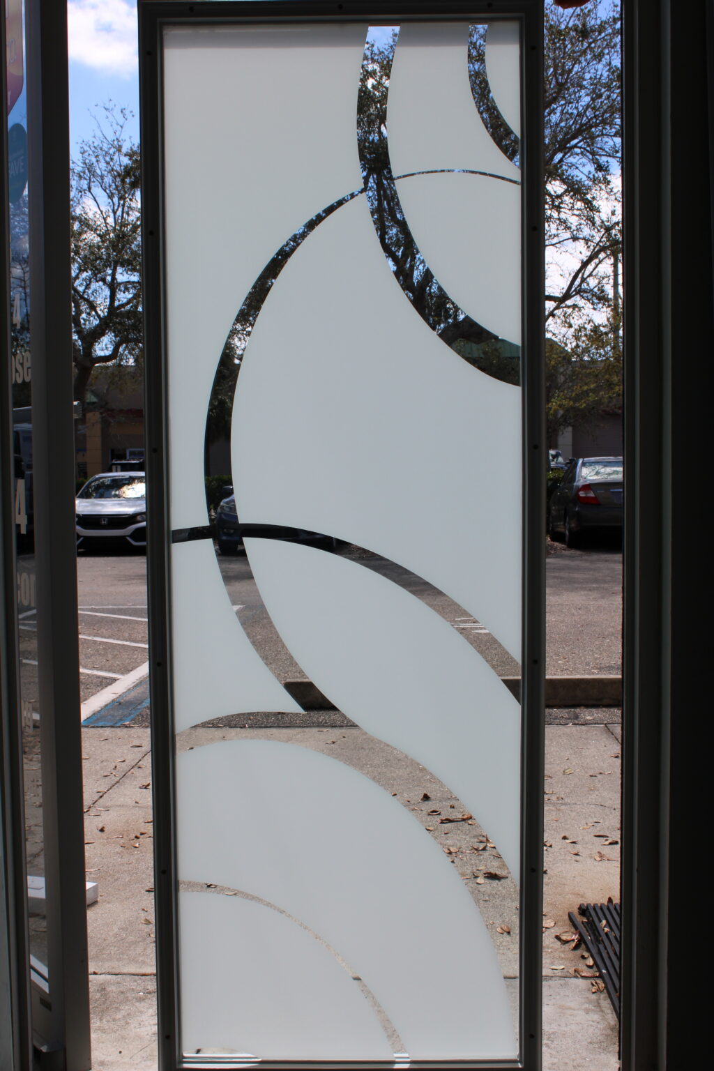 Decorative frosted glass panel with bold curved clear accents in a geometric arc design.