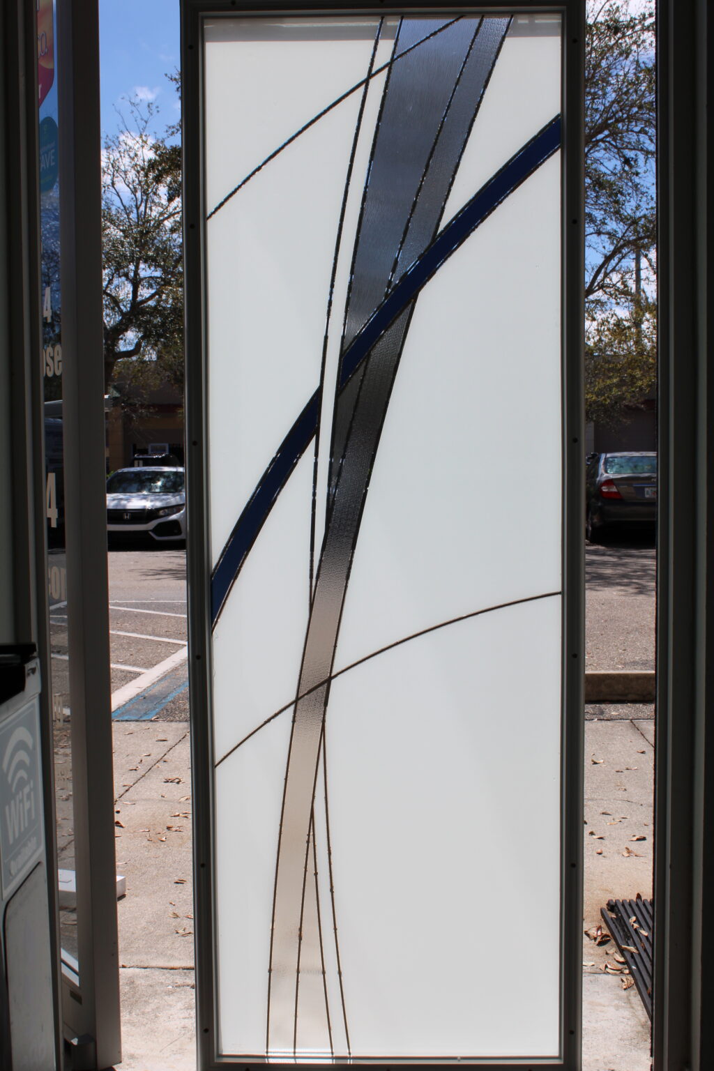 Frosted glass panel with bold linear clear and blue accents in a modern diagonal design.
