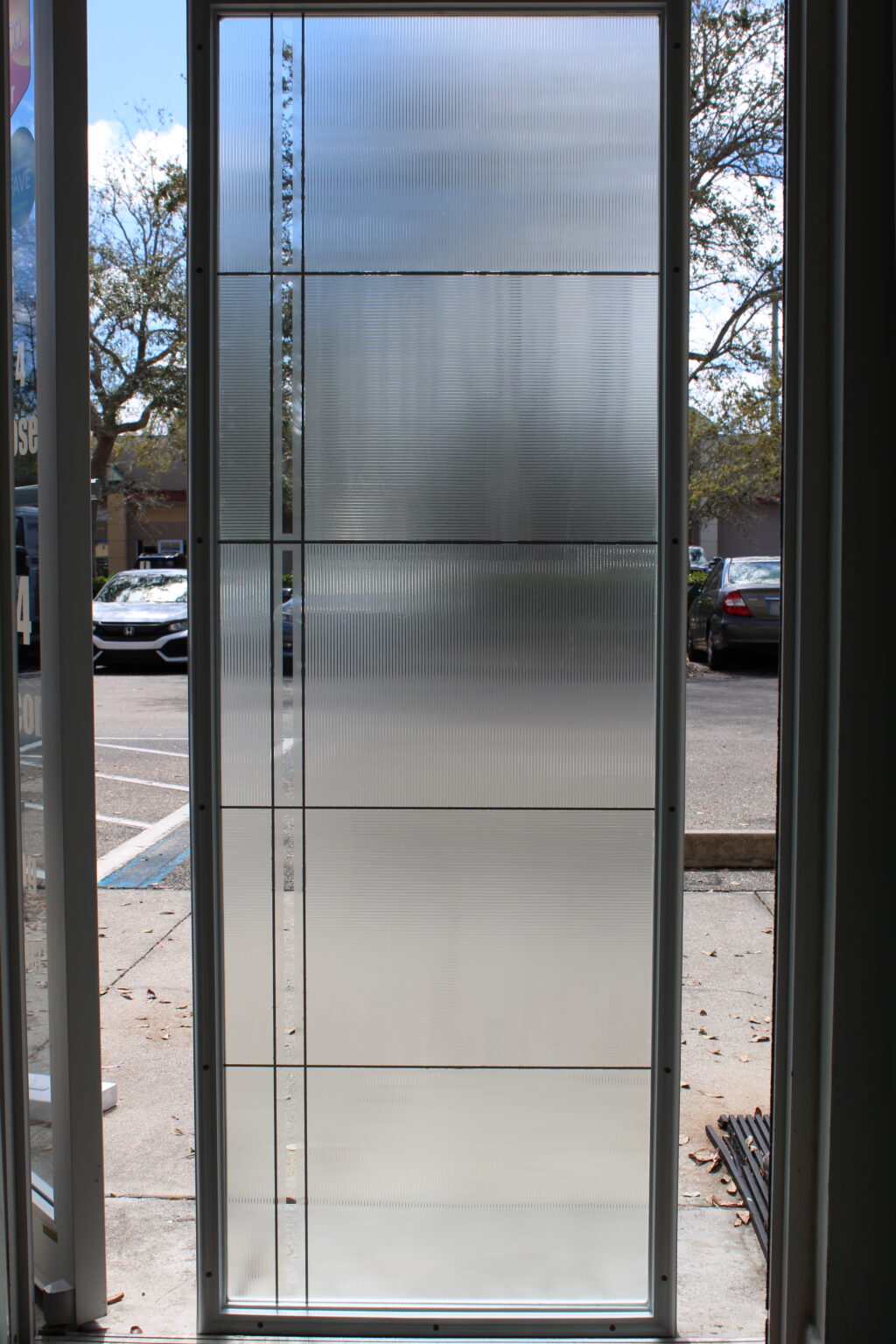 Frosted glass door film with horizontal textured block design and clear accent lines.