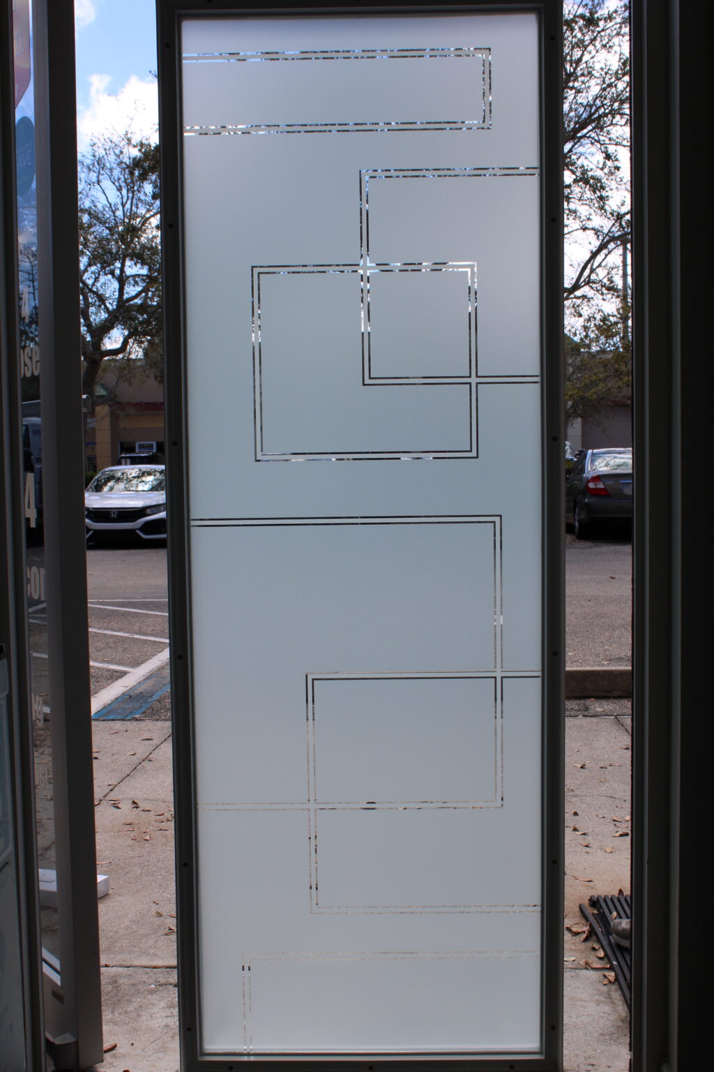 Frosted glass film with layered square outlines and clear cut accents, creating a contemporary geometric design